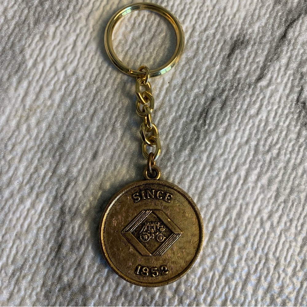 Vintage brass color metal Keychain with stagecoach Emblem